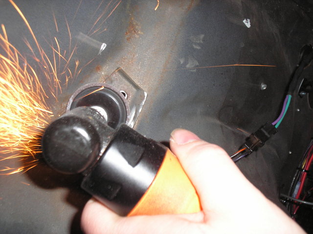 Take an air grinder and sanding disc to smooth the hole flush.